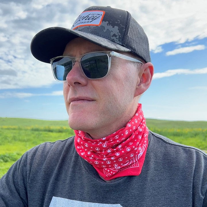 Red and White bandana print multi-functional neck gaiter features CoolNet® UV (95% recycled) - engineered with REPREVE® performance microfiber, HeiQ cooling technology, Polygiene® odor control and has a 4-Way ULTRA STRETCH fabric construction that features UPF 50 sun protection.